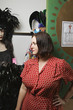Second Hand Store Owner Standing by Costumes