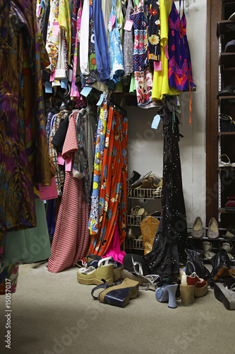 Photo: Crowded Clothing Racks and Piled Shoes in Second Hand Store Crowded Clothing Racks and Piled Shoes in Second Hand Store