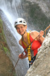 Woman climbing a waterfall