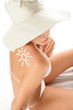 Young woman with sun-shaped sun cream Young woman with sun-shaped sun cream