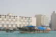Photo: dubai uae a dhow an old wooden sailing vessel filled with cargo leaves the dock in deira. dubai uae a dhow an old wooden sailing vessel filled with cargo leaves the dock in deira.