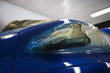 Damaged headlight of blue car