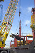 Limassol, Cyprus. Dockside crane unloading steel rods from a freighter