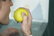 Businessman eating apple at laptop with bar chart