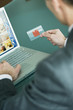 Businessman holding credit card at laptop