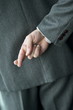 Businessman's fingers crossed