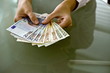 Woman's hands holding euro bills