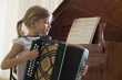 Girl 5-6 playing accordion