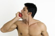 Photo: Fit young man biting an apple Fit young man biting an apple