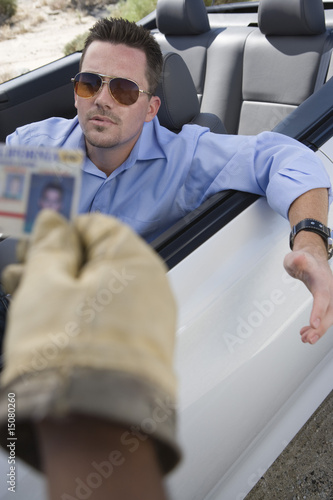 Photo: Police officer checking driver's ID Police officer checking driver's ID