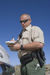 Policeman writing speeding ticket
