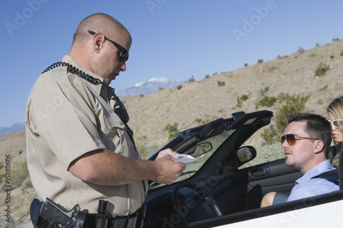 Photo: Police officer checking on driver in desert Police officer checking on driver in desert