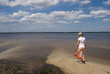 A girl walking near a lake