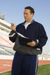 Sports coach looking at stopwatch