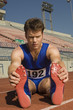 Runner on a track, stretching