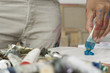 artist squeezing paint onto palette