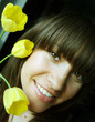 Young charming woman with bouquet of tulips