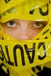 Face of teenage girl wrapped in caution tape Face of teenage girl wrapped in caution tape