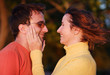 Young woman fondles her boyfriend's face with tenderness