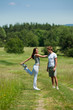Man and woman stretching in a meadow