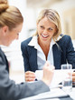 Happy business executive at a meeting with colleagues