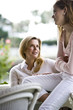 Mother and teen girl having conversation outdoors
