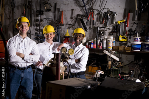 Photo: Multi-ethnic coworkers in office maintenance area Multi-ethnic coworkers in office maintenance area
