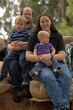 Family of 4 sitting on rocks