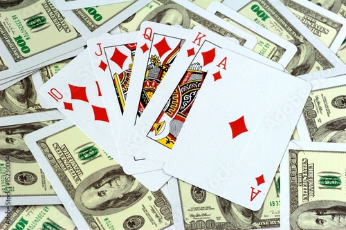 Photo: Royal Flush of Diamonds on money background Royal Flush of Diamonds on money background