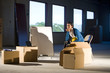 Young woman in empty office space with moving boxes