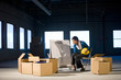 Young woman in empty office space with moving boxes