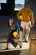 Business people holding hard hats in unfinished office space
