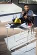 Worker in unfinished office space with feet up on folding table