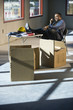 Worker in unfinished office space with feet up on folding table