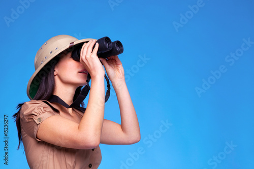 Photo: Woman in safari hat searching with binoculars Woman in safari hat searching with binoculars