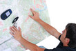Man sitting and looking at maps in his hands