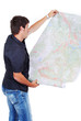 Man standing and looking at maps in his hands