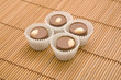 four chocolate sweets on bamboo mat