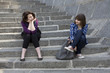 Two urban teen girls sitting on stairs Two urban teen girls sitting on stairs