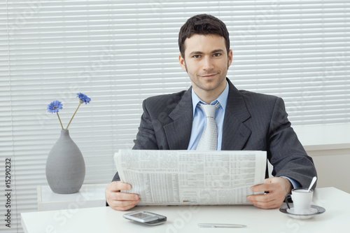 Businessman reading newspaper