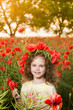 Cute little girl in the poppy field
