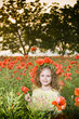 Cute little girl in the poppy field