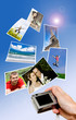 Digital camera and photographs against blue background Digital camera and photographs against blue background