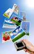 Digital camera and photographs against blue background Digital camera and photographs against blue background