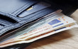 Euro notes protruding from wallet