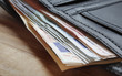 Euro notes protruding from wallet