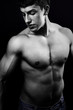 Muscular young man in the dark