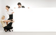 Business people pulling big white board,
