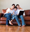 Parents and kid using a laptop with thumbs up
