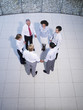 Aerial view of six office workers holding hands